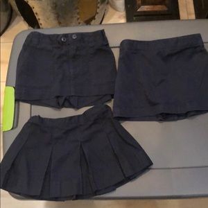 3 Navy skorts and 1 pair of black uniform pants